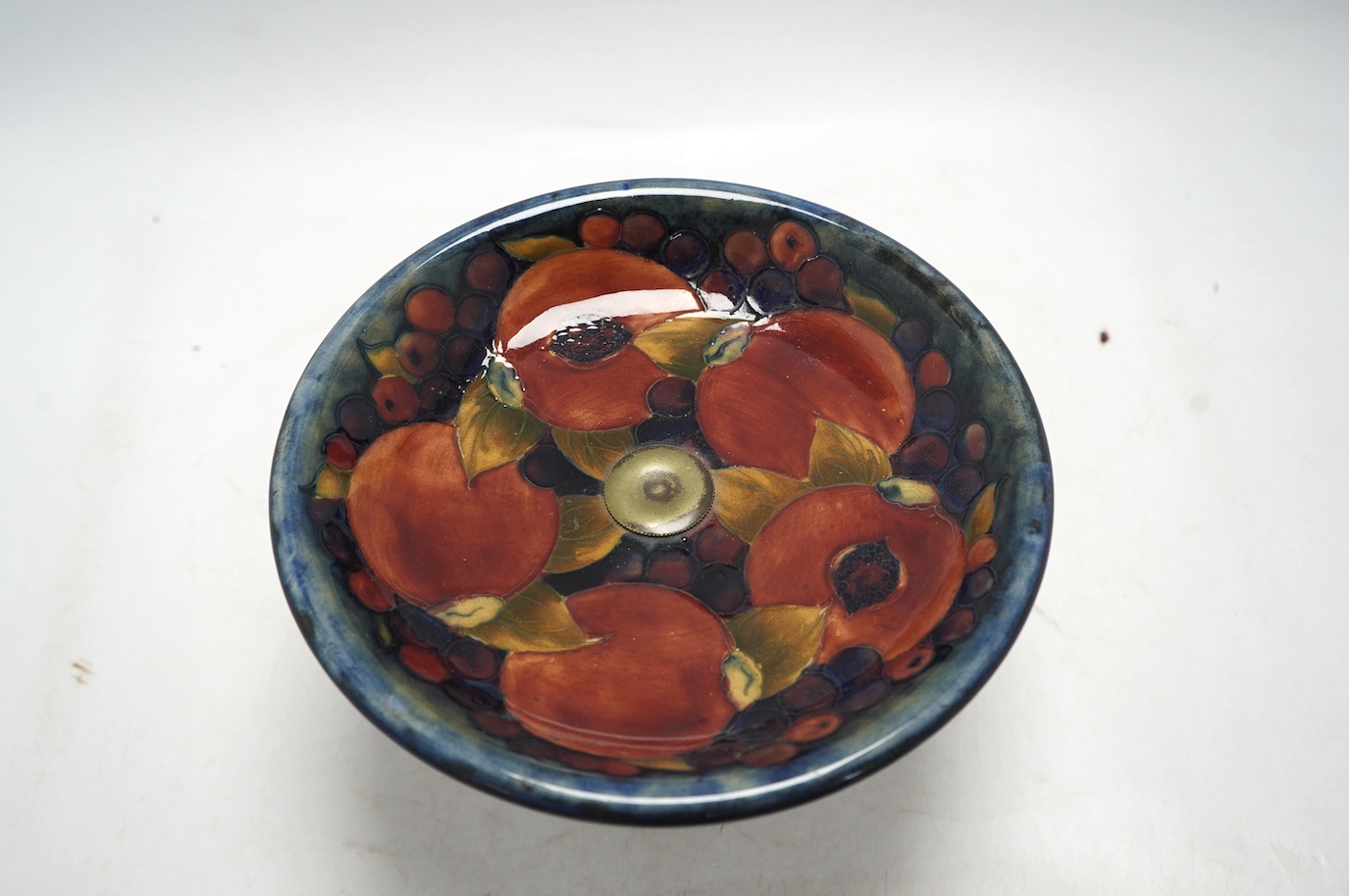 A Moorcroft Pomegranate comport, on plated metal pedestal, 14.5cm. Condition - fair, some wear to plating